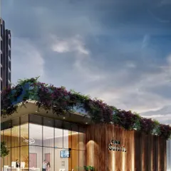 A rendering of the entrance to Club Solaris. The design combines natural wood cladding with large glass walls and a green roof, creating a welcoming and modern clubhouse that connects with the surrounding landscape.