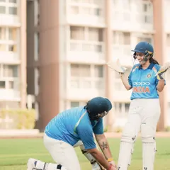 It's the small, caring gestures that show the strength of a partnership. Here, he helps her with her cricket pads, a candid moment of teamwork and affection during their themed shoot.