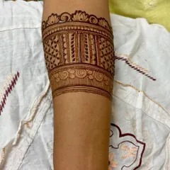 A custom armband or "bajuband" design. This is a great alternative or addition to hand mehendi for a unique look.