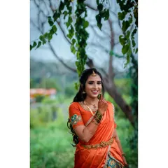 A lovely candid portrait of a bride-to-be at her engagement, looking radiant in her traditional half saree.