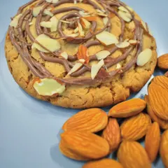 This is not your regular cookie. My Almond Croissant Cookie is soft and golden, filled with a rich chocolate frangipane and topped with toasted almond slivers for a buttery crunch.