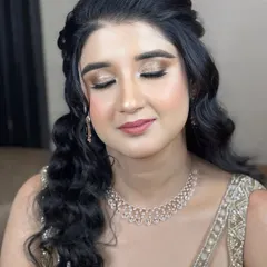 An elegant engagement look with soft, shimmery eye makeup and loose curls. This style is perfect for a client who wants to look glamorous yet feel comfortable.