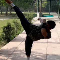 My personal practice includes maintaining peak flexibility for powerful movements. This high side kick demonstrates the range of motion that I help my students work towards.