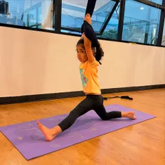 Using the aerial hammock for support while practicing a split. This is a great way for kids to work on their flexibility and achieve deeper stretches.