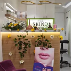 Another view of the reception area at Studio SKINQ, showing how our floral decorations enhance the existing modern decor. We work to complement the brand's aesthetic.