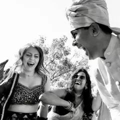 The pure joy of a Baraat, captured in high-contrast black and white. This candid shot freezes a moment of uninhibited laughter and celebration.