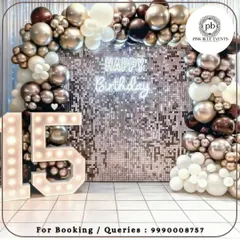 Celebrating a milestone birthday deserves a touch of glamour. This chic setup for a 15th birthday features a sparkling shimmer wall, a custom neon sign, and bold marquee numbers, creating the perfect backdrop for photos and memories.