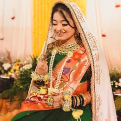 A bride looking lovely for her Haldi ceremony in a custom floral jewellery set.
