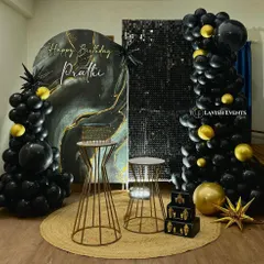 A sophisticated black, gold, and marble-effect backdrop paired with a shimmer wall panel. This setup is all about texture, contrast, and modern elegance.