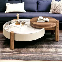 Another view of the nesting coffee table, showing how it looks in a living room setting. The two levels and materials add visual interest.