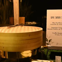 Our live sushi station, featuring a menu of Blue Pea Flower Sushi, Asparagus Tempura Sushi, and Truffle Shiitake Sushi, ready to delight guests.