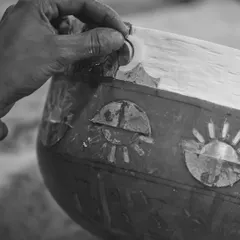 A close-up of the meticulous handcraftsmanship involved in creating the 'Forces of Nature' pillar. This black and white shot highlights the artisan's touch, showing how our conceptual design was brought to life through traditional techniques.
