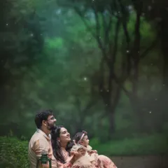 A family sitting together in the woods as dusk settles, with the warm glow of a lantern and a sprinkle of magical fireflies. This is more than a portrait; it’s a fairytale moment created just for them.