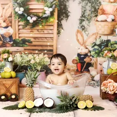 A vibrant and cheerful fruit bath session, perfect for a fun and unique toddler photoshoot. The colorful setup includes fresh fruits and whimsical props like Easter bunnies, creating a lively scene.