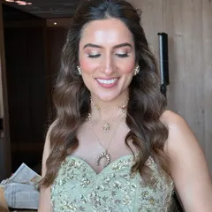 A classic and chic makeup look with a focus on glowing skin and softly defined eyes. This style is perfect for a Mehendi or engagement, offering a polished yet natural finish.