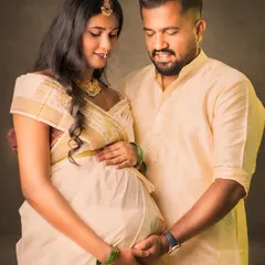 A portrait of togetherness, celebrating heritage. This couple, dressed in traditional cream-colored attire, shares a gentle moment, showcasing the deep connection and anticipation that I love to capture.