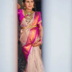 A beautifully framed portrait of the mother-to-be during her baby shower, captured through a doorway to create a sense of intimacy and anticipation.