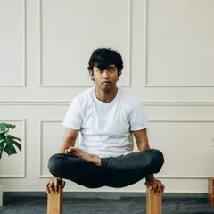 By elevating the hands on blocks in Tolasana (Scale Pose), you create the space needed to lift off the ground. This modification builds immense core and arm strength.