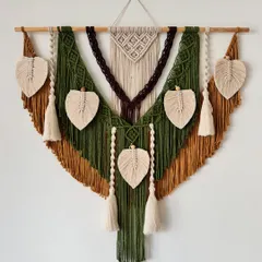 I love how the earthy colors came together in this custom wall hanging. The combination of olive green, mustard, and dark brown, accented with cream-colored leaves and tassels, creates a warm and inviting feel. This piece is perfect for adding a touch of nature-inspired art to your home.