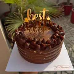 For the "Best Dad Ever," this rich Belgian chocolate cake is a perfect choice. It's decorated with chocolate rosettes and a custom cake topper to celebrate him on Father's Day.
