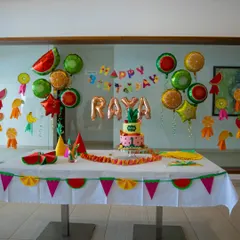 A vibrant and fun fruit-themed party setup for a first birthday. I design the entire cake table experience, including custom banners, themed balloons, and coordinated tableware to create the perfect photo opportunity.