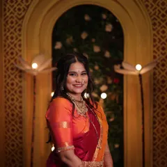 A beautiful portrait of the client ready for her puja. The look is completed with traditional gold jewelry and a radiant makeup finish.