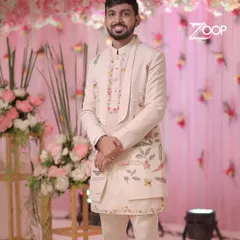 Our client is ready for his engagement ceremony in a custom Indo-Western outfit. The asymmetrical jacket with delicate floral embroidery offers a modern twist on traditional groomswear.