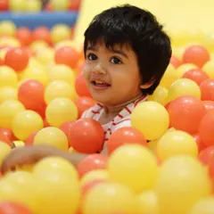 This is the look of pure, simple joy. We love seeing kids light up as they dive into our giant ball pit, a favorite spot for endless fun and making new friends.