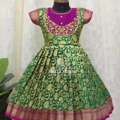 A classic long frock made from green and magenta Banarasi silk. The yoke is embroidered, and the full flared skirt has a traditional border.