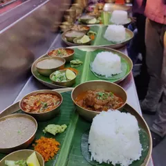 Our thalis getting ready to be served at a busy pop-up. Each plate is carefully assembled with a mound of Indrayani rice, different curries, and fresh accompaniments, all served on a traditional banana leaf for that authentic touch.