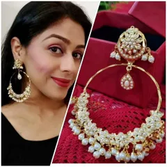 The classic white Jadau Chandbali earrings. These hoops are adorned with clusters of pearls, offering a timeless and elegant look that pairs well with almost any ethnic outfit.
