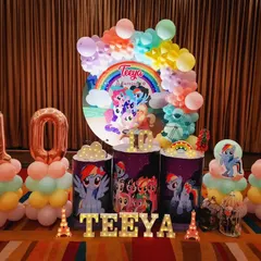 A vibrant My Little Pony party for Teeya's 10th birthday. The decor is filled with rainbows and all her favorite pony characters, complete with large foil number balloons.