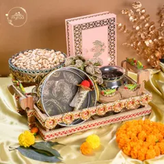 A complete Karwa Chauth hamper, thoughtfully curated with a decorative thali, sieve, pistachios, and a box of my signature sweets. It has everything needed for the special day.