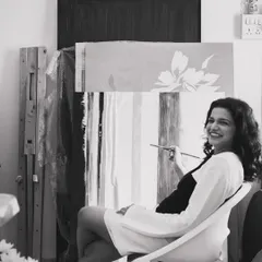 Brush in hand, a smile on my face. This is me in my happy place, sitting in my studio surrounded by canvases. The process isn't always neat, but it's always honest.