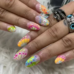 A vibrant and colorful design inspired by thermal imaging. Our artist used a dotting technique with multiple neon polishes to create this eye-catching, psychedelic effect on long nails.