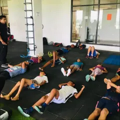 Cool-down and recovery are just as important as the workout itself. Here, the group takes a moment for guided stretching and breathing exercises after a tough session.