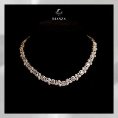 This collar-bone necklace features a stunning array of emerald-cut solitaires, each framed by marquise and pear-shaped diamonds. It is a modern take on classic bridal luxury.