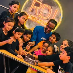 A beautiful moment from our Children's Day celebration, with all the kids gathered around the cake with their instructor. These events strengthen the bond between our students and teachers.
