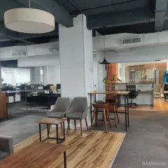 We design office spaces that are more than just desks. This open-plan office includes breakout areas with comfortable seating for informal meetings and collaboration.
