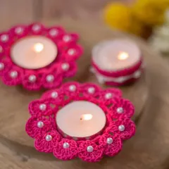 This set features our bright pink, flower-shaped diya coasters with delicate pearl bead details, shown alongside a matching diya jacket. You can mix and match styles to create your perfect festive look.