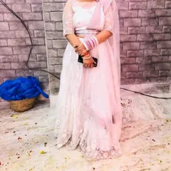 This elegant white embroidered lehenga is a popular choice for engagements and daytime events. The delicate threadwork gives it a soft, romantic feel.