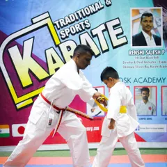 A significant moment in any student's journey is the awarding of a new belt. Here, I am personally fitting a yellow belt, marking a student's progress and dedication. This is a key part of the structured advancement in my program.