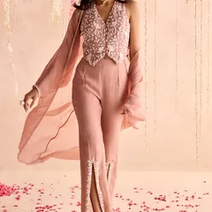 Modern, chic, and powerful. This dusty pink set features a hand-embroidered waistcoat-style top and stylish pants with embroidered slits. It's a perfect look for a contemporary wedding guest.