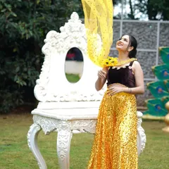 This shot captures a playful moment during a fashion shoot. The makeup is radiant and enhances the model's features, working in harmony with the bright, sunny colors of her outfit.