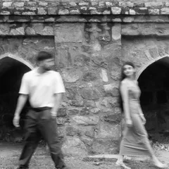 An artistic motion-blur photo in black and white. This creative technique captures a feeling of movement and the passage of time, with the couple as the constant.