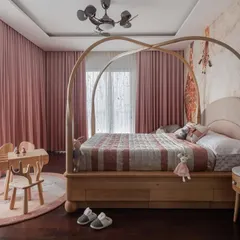 For this daughter's room, we designed a whimsical yet elegant four-poster bed with a gentle arch. The solid wood frame and soft, curved headboard create a timeless piece that feels both playful for a child and sophisticated enough to grow with them through the years.