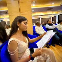 Here I am reviewing the event flow before going on stage. As a professional public speaker, being well prepared allows me to be more present and interactive with the audience once the event starts.