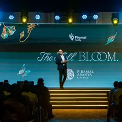 A speaker commands the stage at the Piramal Realty conference. My job is to ensure the lighting, sound, and backdrop all work together to amplify their presence and message.