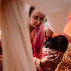 An emotional moment during a wedding ritual, capturing the bride's expression. We focus on the small, meaningful interactions that tell a larger story.
