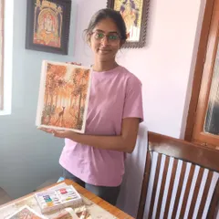 My student Harshni proudly displays her finished watercolour painting of a deer in a sunlit forest. It's always a joy to see students happy with their creations.